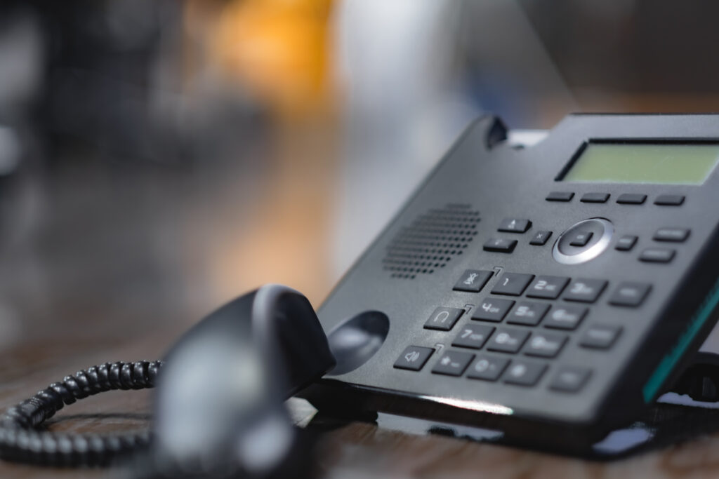 Closeup ip phone black color on the wood floor, Bussiness connec
